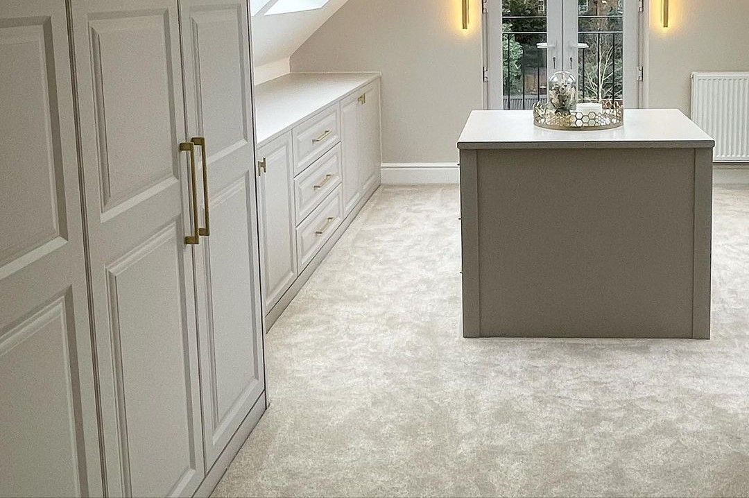 Grey carpet with pink sofa and blue walls